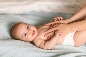 mother massaging her baby's tummy